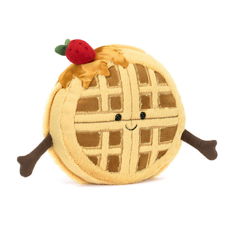 Amuseables Rene Waffle is a soft plush toy shaped like a round waffle with a smiling face, outstretched arms, syrup drizzle, and a small red strawberry on top.