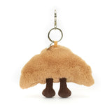 Rear view of a plush Amuseables Croissant Bag Charm with legs on a white background