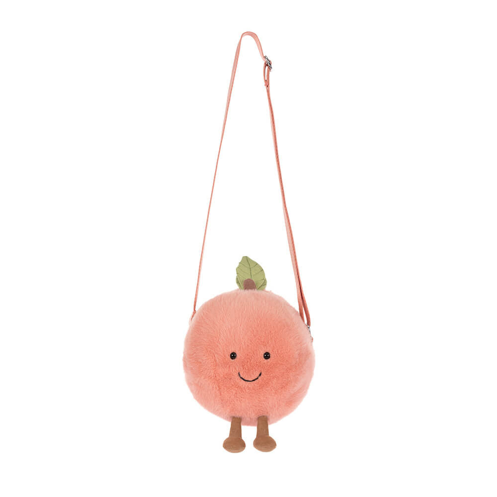 Amuseables Peach Shoulder Bag is a round, plush peach-shaped bag with a smiling face, leaf detail on top, and adjustable peach-colored shoulder strap.