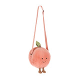 Amuseables Peach Shoulder Bag is a soft, plush peach-shaped bag with a smiling face, small feet, a green leaf detail, and an adjustable peach-colored shoulder strap.