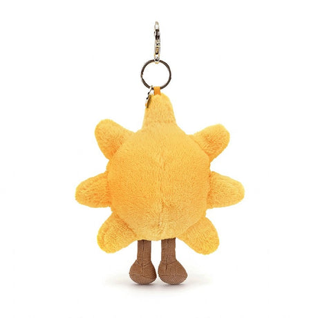 Amuseables Sun Bag Charm is a soft yellow sun-shaped plush keychain with small legs and a metal clip for attaching to bags or keys.