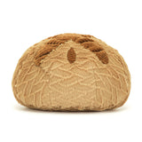 Soft, plush toy shaped like a round loaf of bread with textured brown crust details, representing Amuseables Sourdough in a friendly and cozy design.