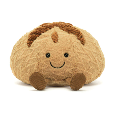 Soft plush toy resembling a smiling sourdough loaf with textured brown details and small round eyes, called Amuseables Sourdough.