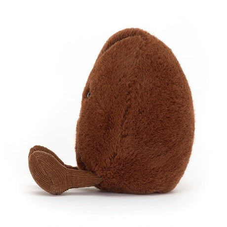 Soft and cuddly plush toy shaped like a coffee bean with a textured brown surface and small embroidered eyes, called Amuseables Coffee Bean.