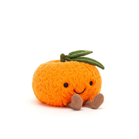 Amuseables Clementine is a soft, knitted orange plush toy with a smiling face, green fabric leaves on top, and small brown feet, perfect as a kid’s stuffed toy.