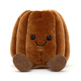 Brown plush Amuseables Carole Canelé with a smiling face on a white background