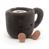A soft, plush Amuseables Coffee Cup toy with a smiling face and small brown fabric feet, designed as a cute and cuddly stuffed companion.