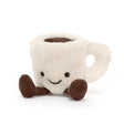 A plush white Amuseables Espresso Cup with a smiling face and brown fabric legs, designed as a cute and cuddly stuffed toy.