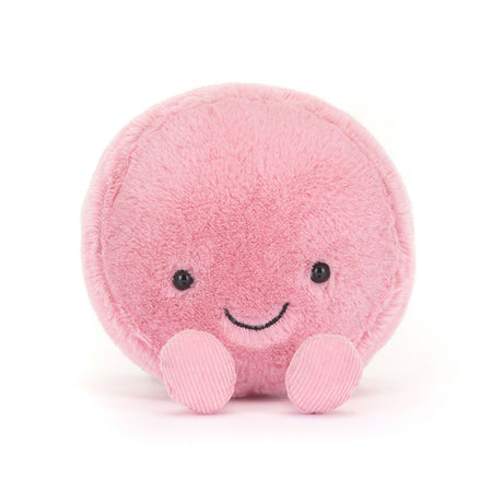 Soft pink round plush toy with a smiling face and small feet, designed as the Amuseables Mia Macaron, perfect as a cute children's plush or kid's birthday gift.