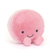 Soft pink plush toy resembling a smiling macaron with small round eyes and two tiny feet, designed as the Amuseables Mia Macaron for children and kids' collections.