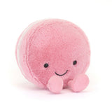 Soft pink plush toy resembling a smiling macaron with small round eyes and two tiny feet, designed as the Amuseables Mia Macaron for children and kids' collections.