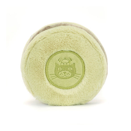 Soft green plush toy shaped like a macaron with an embroidered cat face in the center, designed as the Amuseables Max Macaron for kids.