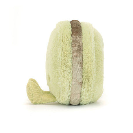 Soft plush toy shaped like a light green macaron with textured fabric and a brown filling, representing the Amuseables Max Macaron.