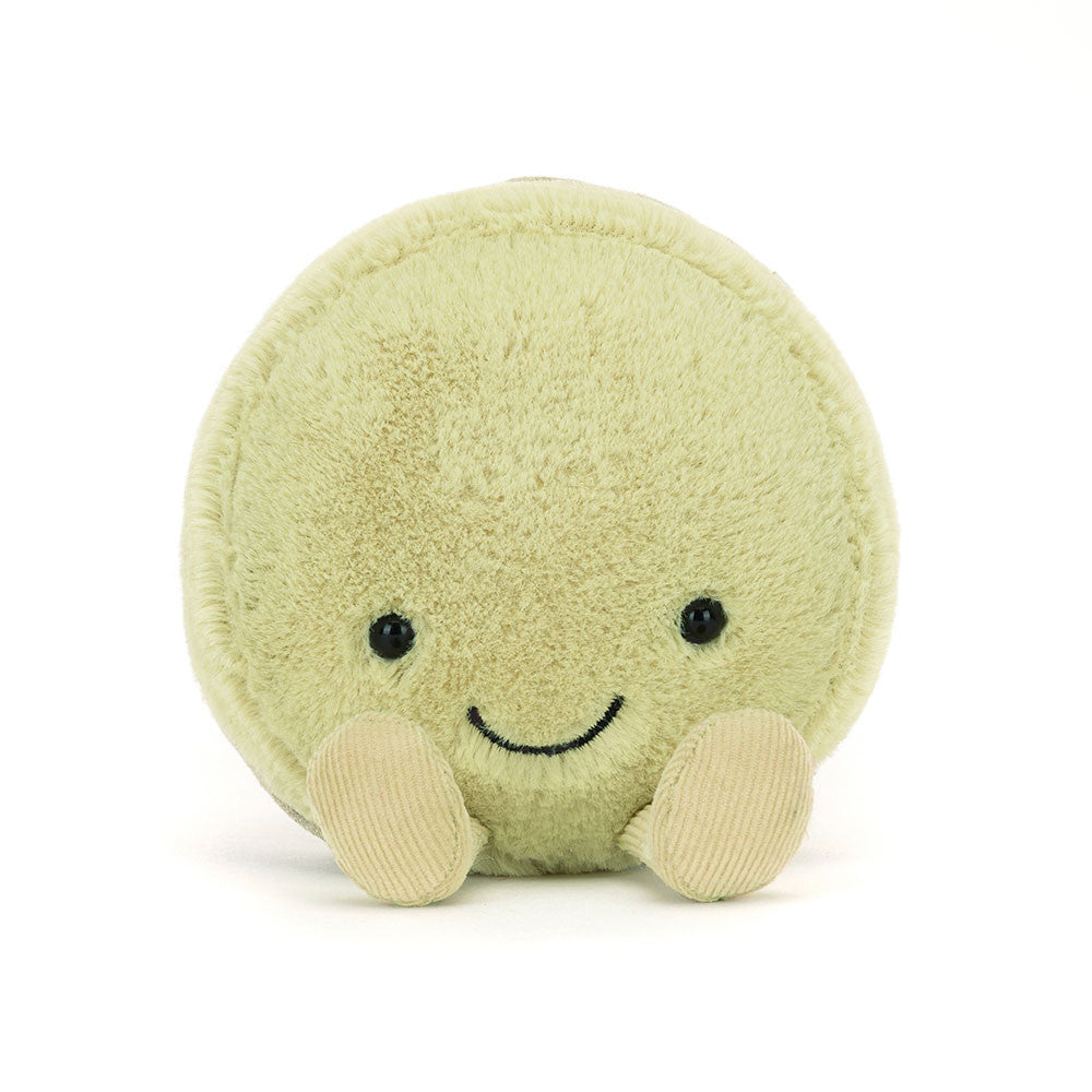 Soft plush toy in the shape of a round macaron with a smiling face and small feet, known as the Amuseables Max Macaron, perfect for a kid’s gift.