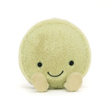 Soft plush toy in the shape of a round macaron with a smiling face and small feet, known as the Amuseables Max Macaron, perfect for a kid’s gift.