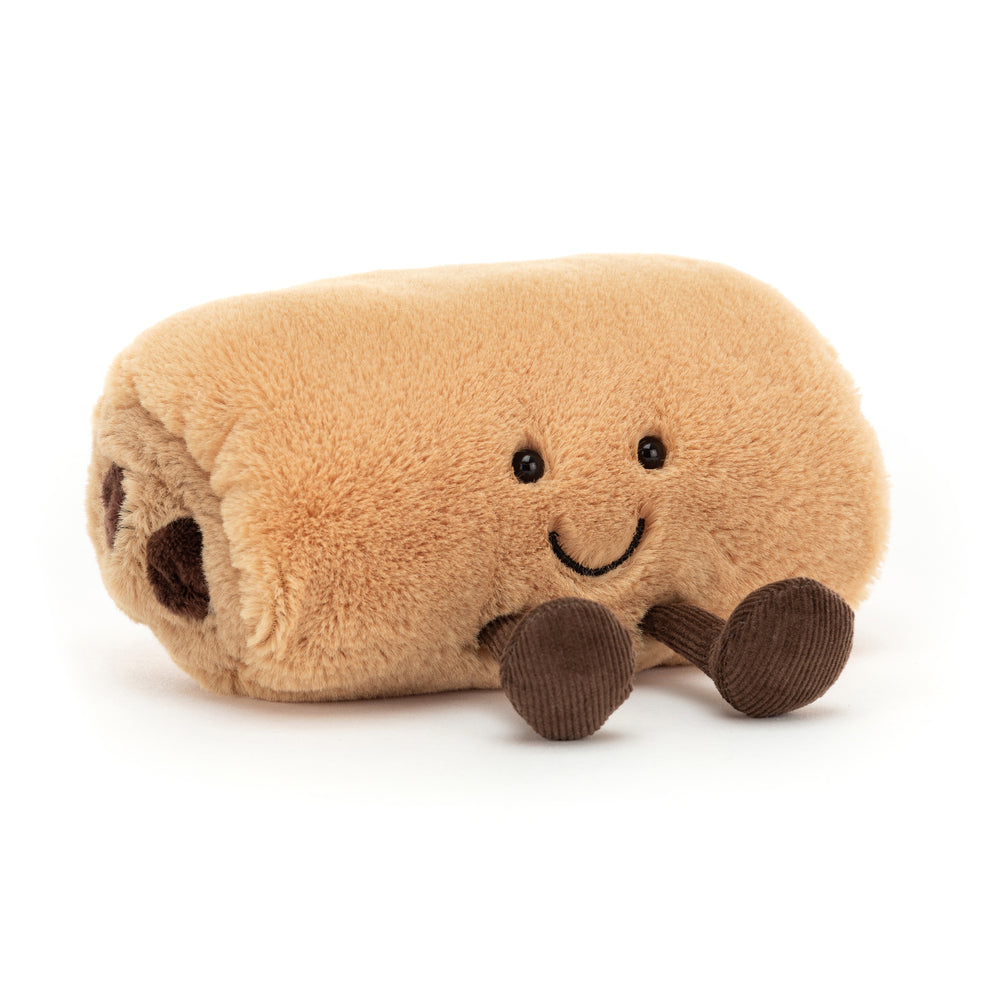 Soft plush toy resembling a smiling pain au chocolat pastry with small brown legs, named Amuseables Pain Au Chocolat, perfect as a cute gift or playful companion.