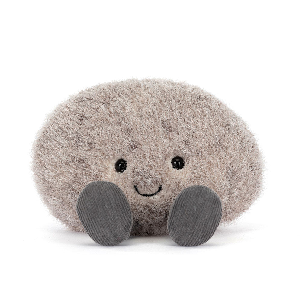 Soft and fluffy plush toy in the shape of a smiling pebble with small black eyes and gray feet, designed as the Amuseables Pebble for kids and collectors.