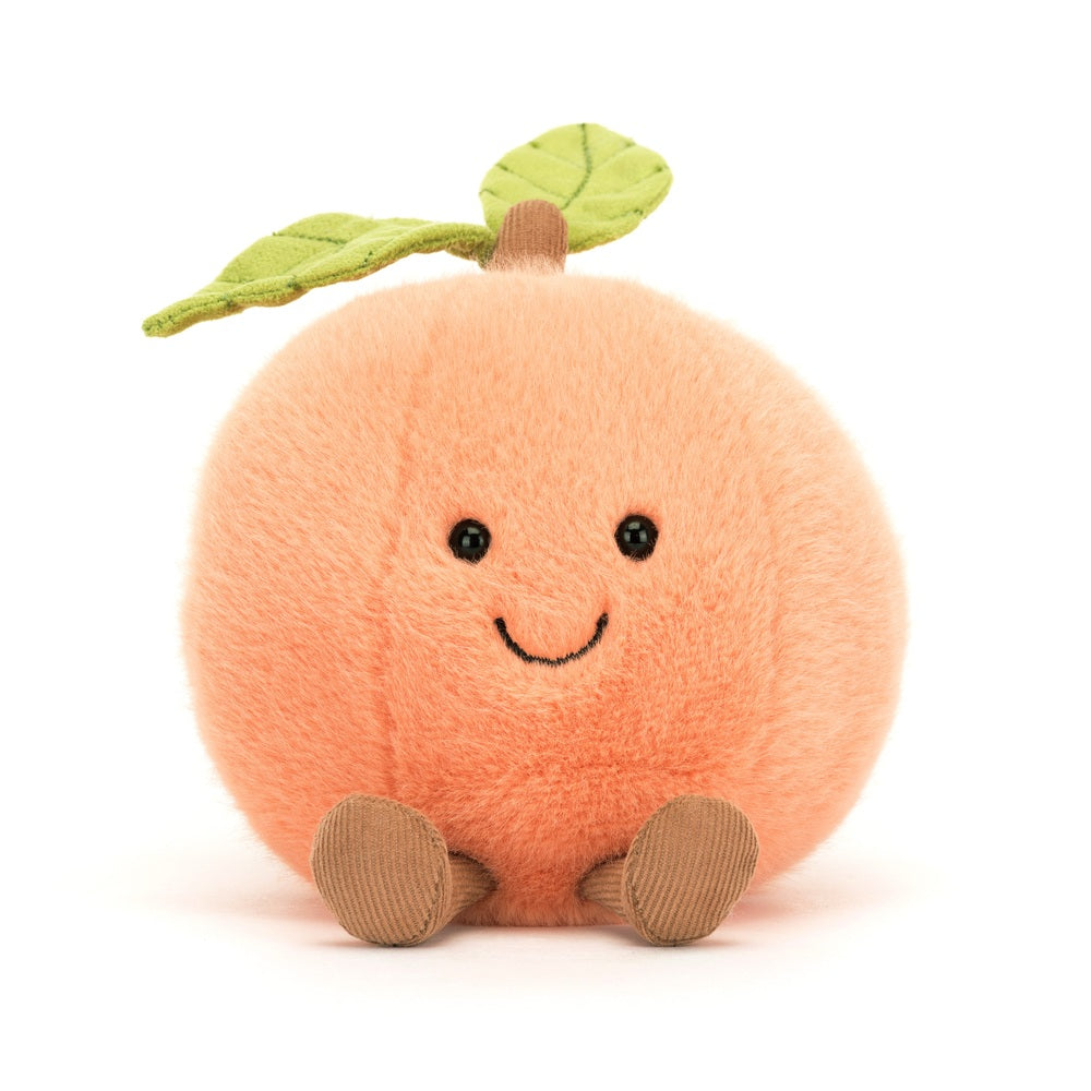 Amuseables Peach is a soft, round plush toy with a smiling face, felt green leaves on top, and small corduroy feet, perfect as a cute toddler toy or kid's gift.