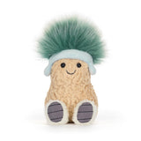 Soft plush toy shaped like a smiling peanut wearing a light blue hat with a fluffy green pompom, known as Amuseables Peanut 'Après Ski'.