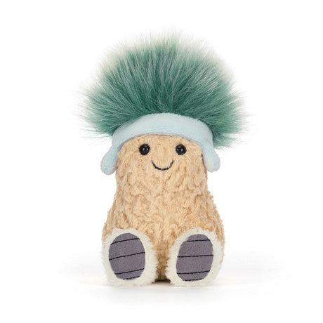 Soft plush toy shaped like a smiling peanut wearing a light blue hat with a fluffy green pompom, known as Amuseables Peanut 'Après Ski'.