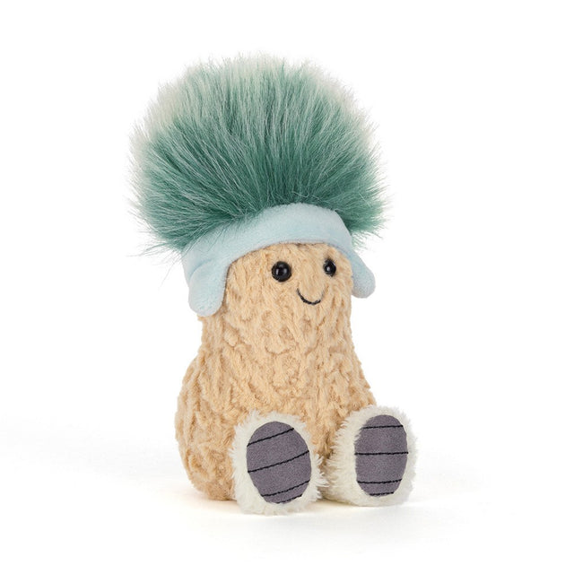 Plush toy of a smiling peanut wearing a light blue hat with a large fluffy green pom-pom and cozy boots, called Amuseables Peanut 'Après Ski'.