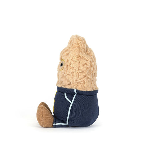Soft plush toy dressed in a navy blue outfit with light blue trim, designed as the Amuseables Peanut Star Student Outfit, sitting upright with textured beige fabric.