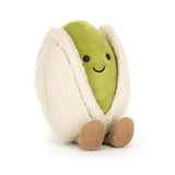 Amuseables Horatio Pistachio is a soft plush toy featuring a smiling green pistachio character with cute black eyes, nestled in a beige fuzzy shell and small brown feet.