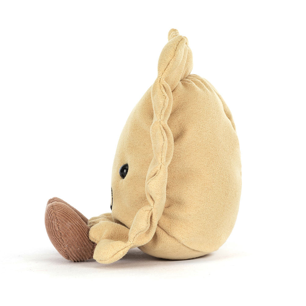 Side view of a beige plush Amuseables Ravioli toy on a white background