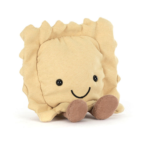 Amuseables Ravioli plush toy with a soft beige body, smiling face, black button eyes, and brown corduroy feet, designed as a cute and cuddly food-inspired stuffed toy.