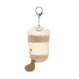 Soft plush charm shaped like a coffee cup with a smiling face and two legs, attached to a keyring, featuring the Coffee-To-Go Charm Amuseables design.