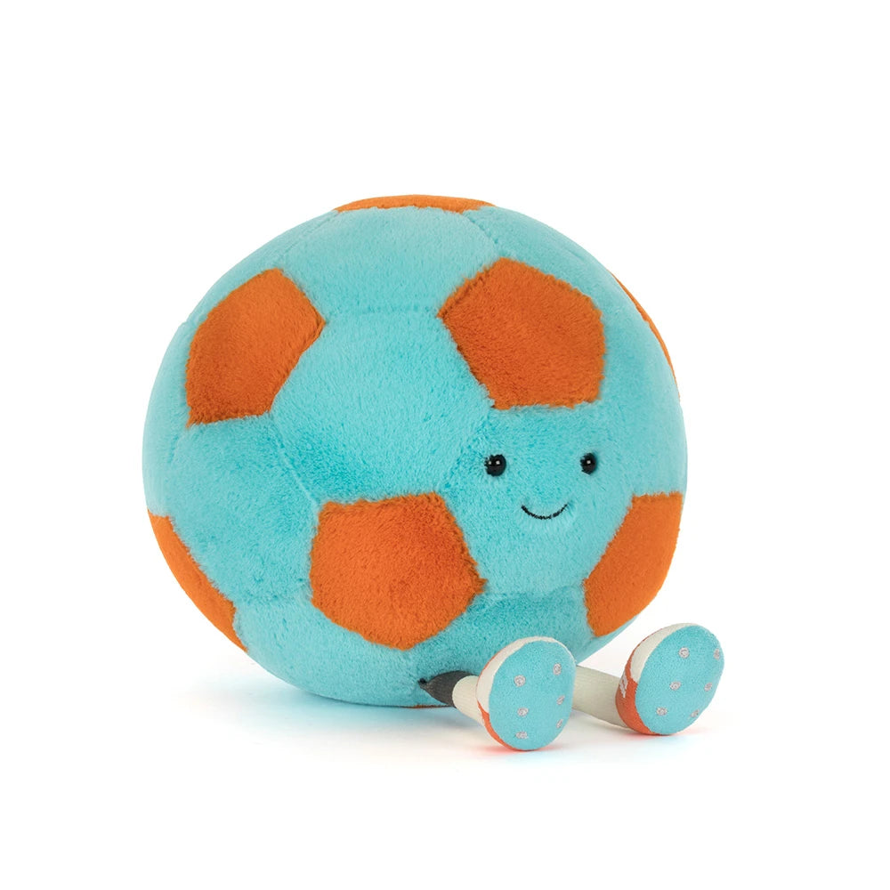 Soft plush toy with turquoise and orange patches, featuring a smiling face and small legs, designed as the Amuseables Jellycat Soccer Ball, a playful kids toy.