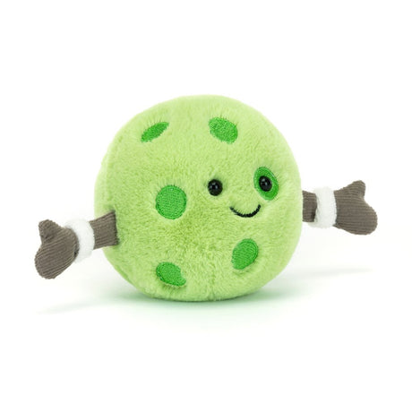 A soft green plush toy with cheerful embroidered facial features and brown glove-like hands, resembling a pickleball character named Amuseables Sports Pickleball.