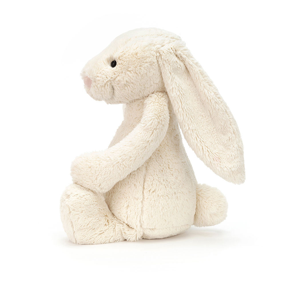 Soft and cuddly plush toy in cream color sitting upright with long floppy ears and a small tail, perfect for kids and collectors, called Bashful Cream Bunny Huge.