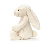 Soft and cuddly plush toy in cream color sitting upright with long floppy ears and a small tail, perfect for kids and collectors, called Bashful Cream Bunny Huge.