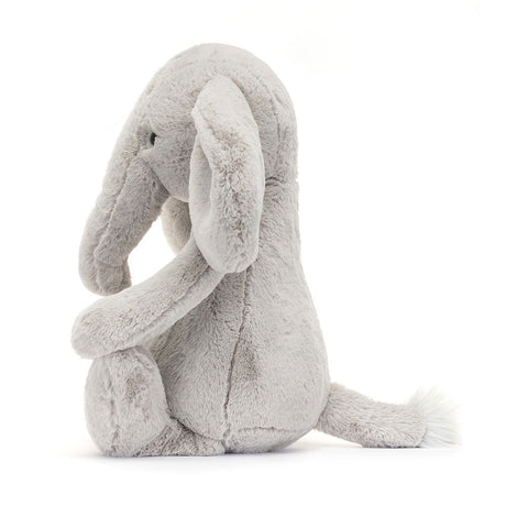 Soft and cuddly plush stuffed animal in light gray with long ears and a tail, designed as Bashful Luxe Elephant Thuddeus for a comforting toddler toy.