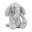 Soft and cuddly gray plush elephant with large floppy ears and a gentle expression, perfect for toddlers and children, named Bashful Luxe Elephant Thuddeus.