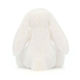 Soft white plush toy with long floppy ears and a fluffy tail, shown from the back, featuring the Bashful Luxe Bunny Luna design.