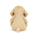 Soft beige plush puppy stuffed animal sitting with back facing forward, showcasing floppy ears and small tail, named Bashful Luxe Puppy Orlando Huge.