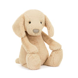 Soft beige plush stuffed dog sitting with floppy ears and embroidered nose, a cute and cuddly Bashful Luxe Puppy Orlando Huge perfect as a toddler toy or kid's gift.