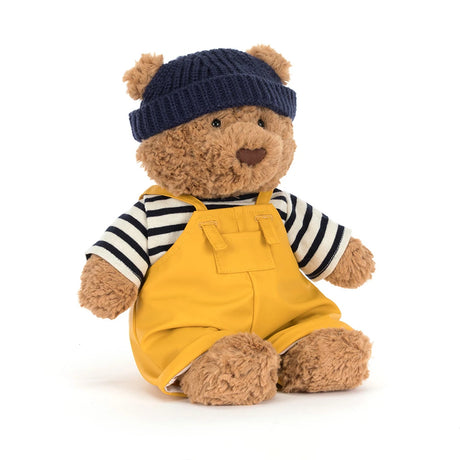 Bartholomew Bear Seafarer Outfit featuring a soft, plush bear dressed in a striped shirt, yellow overalls, and a navy knit hat, perfect for kids' dress-up and stuffed animal collections.