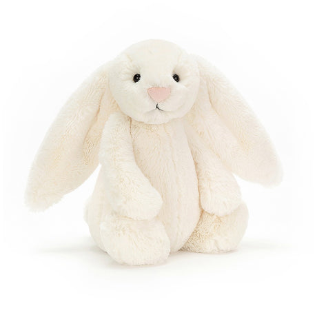 Bashful Cream Bunny Medium, a soft and cuddly cream-colored plush bunny with long floppy ears, perfect as a toddler toy or kid's birthday gift.