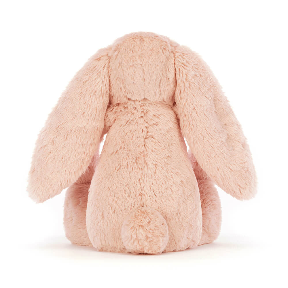 Bashful Blush Bunny Medium plush toy shown from the back, featuring soft blush pink fur and long floppy ears, ideal as a cuddly toddler toy or gift.