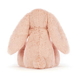Bashful Blush Bunny Medium plush toy shown from the back, featuring soft blush pink fur and long floppy ears, ideal as a cuddly toddler toy or gift.