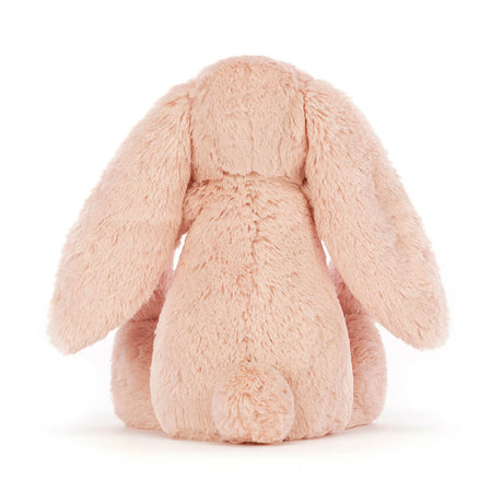 Bashful Blush Bunny Medium plush toy shown from the back, featuring soft blush pink fur and long floppy ears, ideal as a cuddly toddler toy or gift.