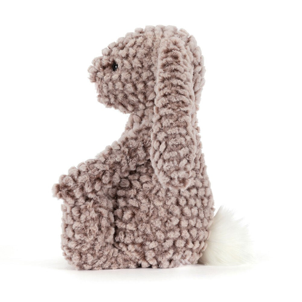 Soft textured plush toy shaped like a bunny with floppy ears and a fluffy white tail, named Bashful Luxe Bunny Pine, perfect as a toddler toy or stuffed animal gift.