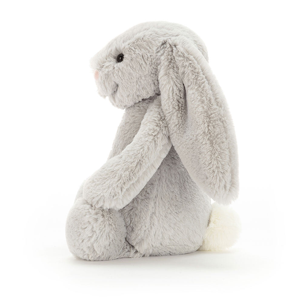 Soft plush gray bunny with long floppy ears and a white tail, shown from the side, representing the Bashful Silver Bunny Medium, a cuddly stuffed animal perfect for children.