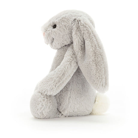 Soft plush gray bunny with long floppy ears and a white tail, shown from the side, representing the Bashful Silver Bunny Medium, a cuddly stuffed animal perfect for children.