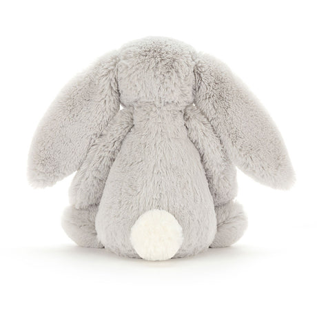 Soft plush Bashful Silver Bunny Medium sitting with its back facing forward, showing its fluffy tail and long ears, perfect as a baby toy or stuffed animal.