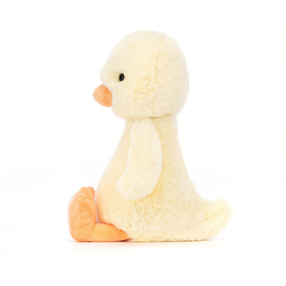 Soft and cuddly Bashful Duckling plush toy with pale yellow fur and orange beak and feet, perfect as a toddler toy or a gentle stuffed animal gift.