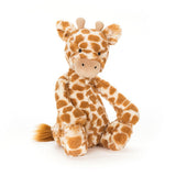 Soft plush Bashful Giraffe toy with orange and white spotted fur, sitting with a friendly expression, designed for comforting play and cuddles.